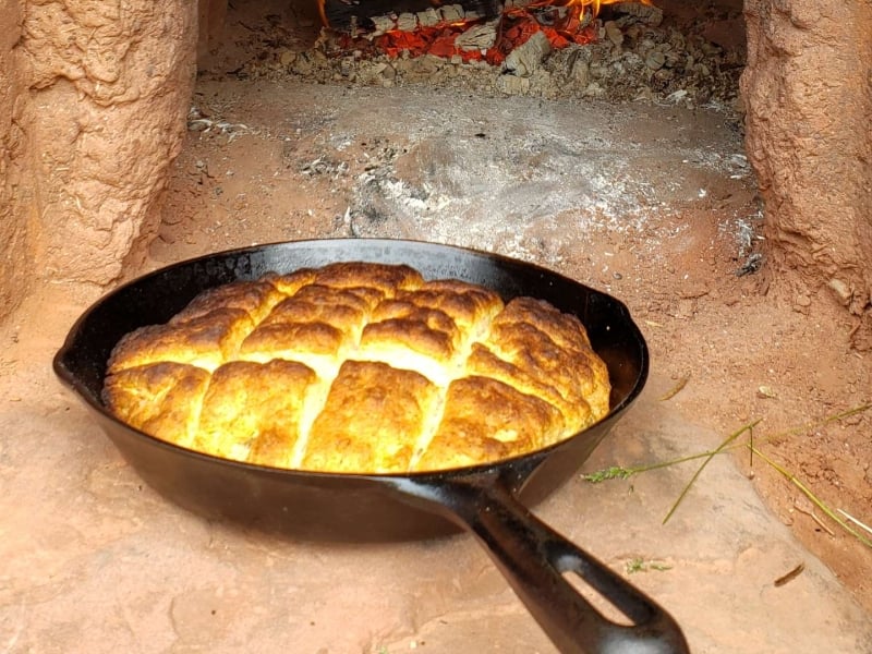 Oven-fresh bannock sits on hearth of outdoor clay oven, Farmers' Bank, PEI