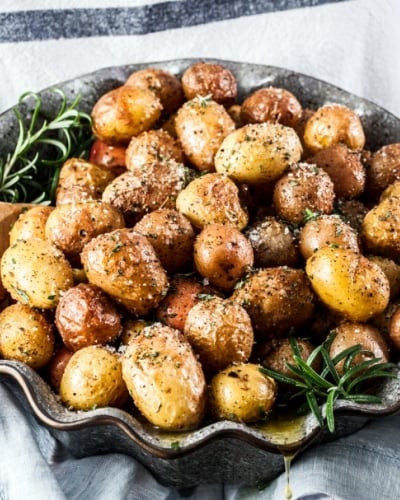 Baked potatoes with rosemary served on a dish