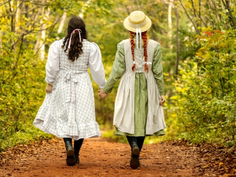 Diana and Anne Shirley walk down Lover's Lane hand in hand under fall colours