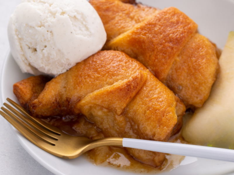 Stock image of apple dumplings with vanilla ice cream