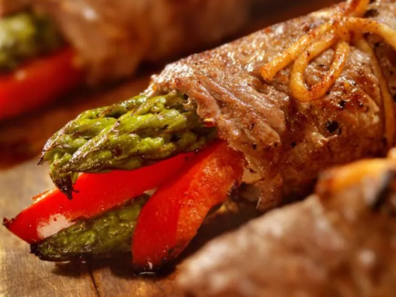 Close up of Beef Involtini with Asparagus on cutting board