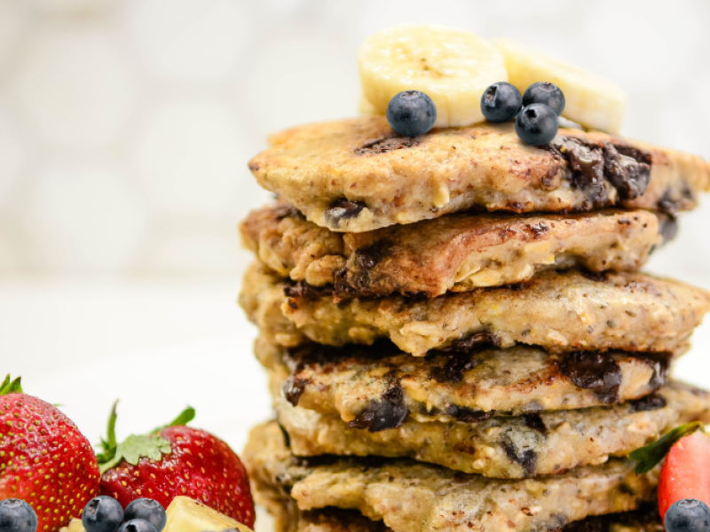 stock image of stack of blueberry pancakes with assorted fruit