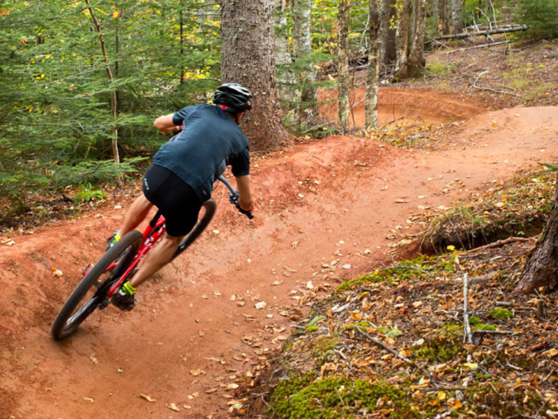 Cyclist on red soil trail at Brookvale 