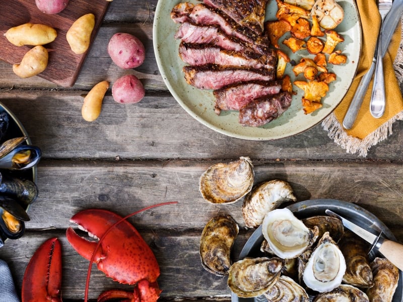 Aerial view of plated PEI oysters, mussels, potatoes, lobster and beef from Canada's Food Island