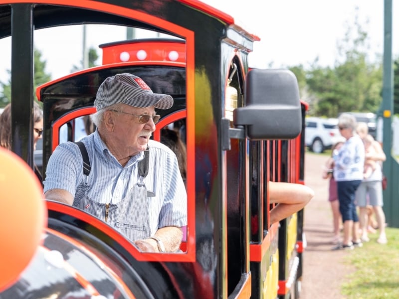 Conductor driving mini train at Elmira Railway Museum, PEI