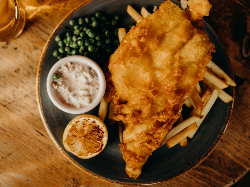 Fish Batter, chips, peas, lemon wedge and tartar sauce