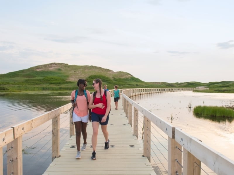 People walk on floating boarwalk at Greenwich - PEI National Park