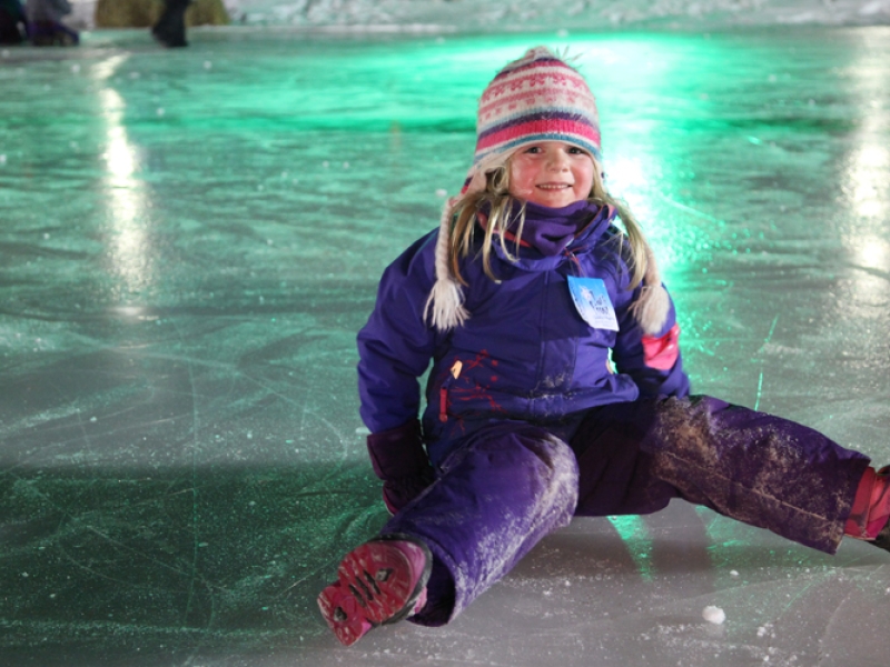 Winter PEI Young girl sits on ice at Jack Frost Festival