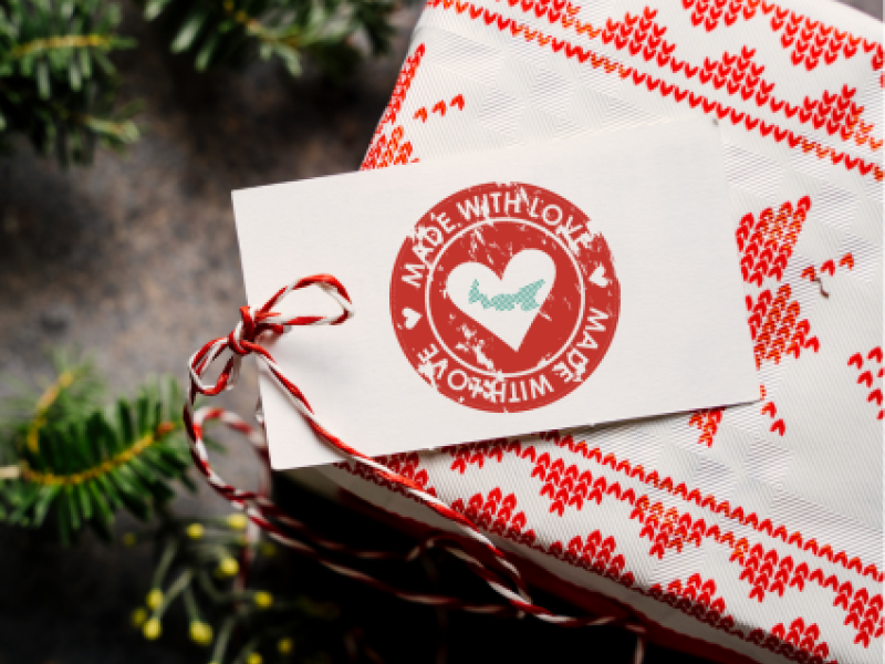 Stock image of box wrapped as Christmas gift with tag "Made with Love" and image of PEI