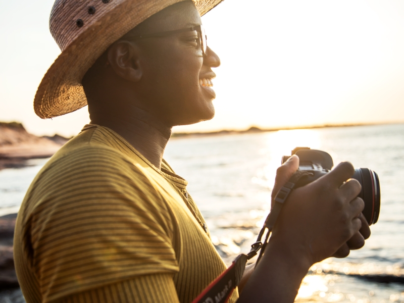 Close-up of guy holding camera at PEI National Park at sunset