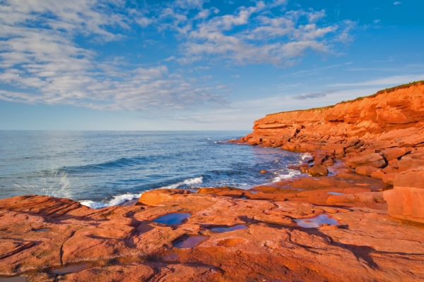 Red cliffs of St. Margaret's Beach under a bright blue sky