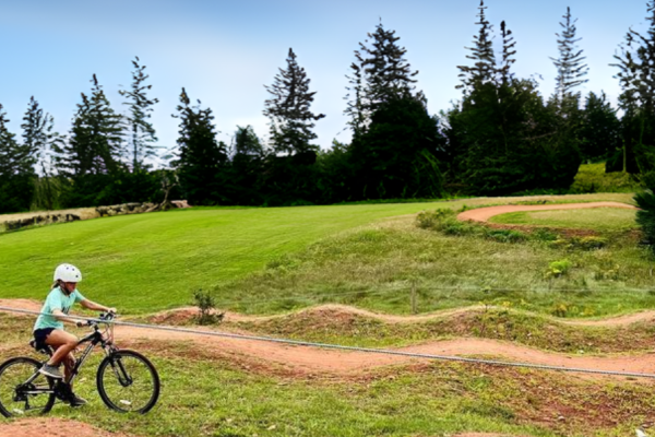 Young cyclist on MTB skills track