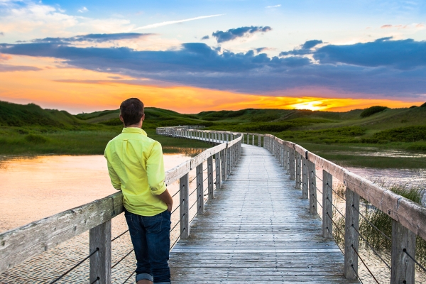 Man standing on Greenwich Boardwalk Sunset