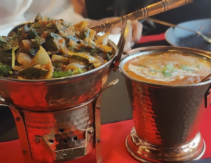 Two Indian dishes served in copper pots