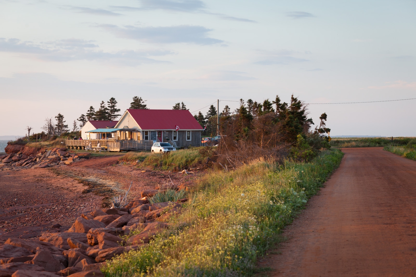 Point Prim Chowder House pictured to the left of red dirt road