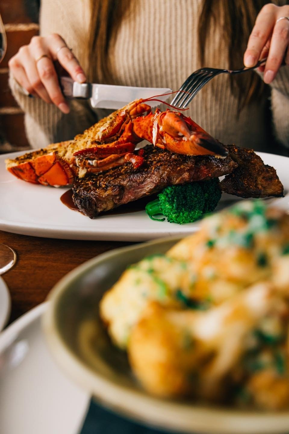 Close up of person dining on surf and turf