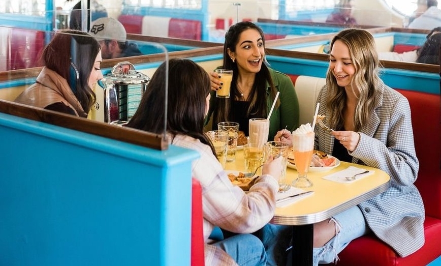 Group of four women in a booth at Starlite Diner