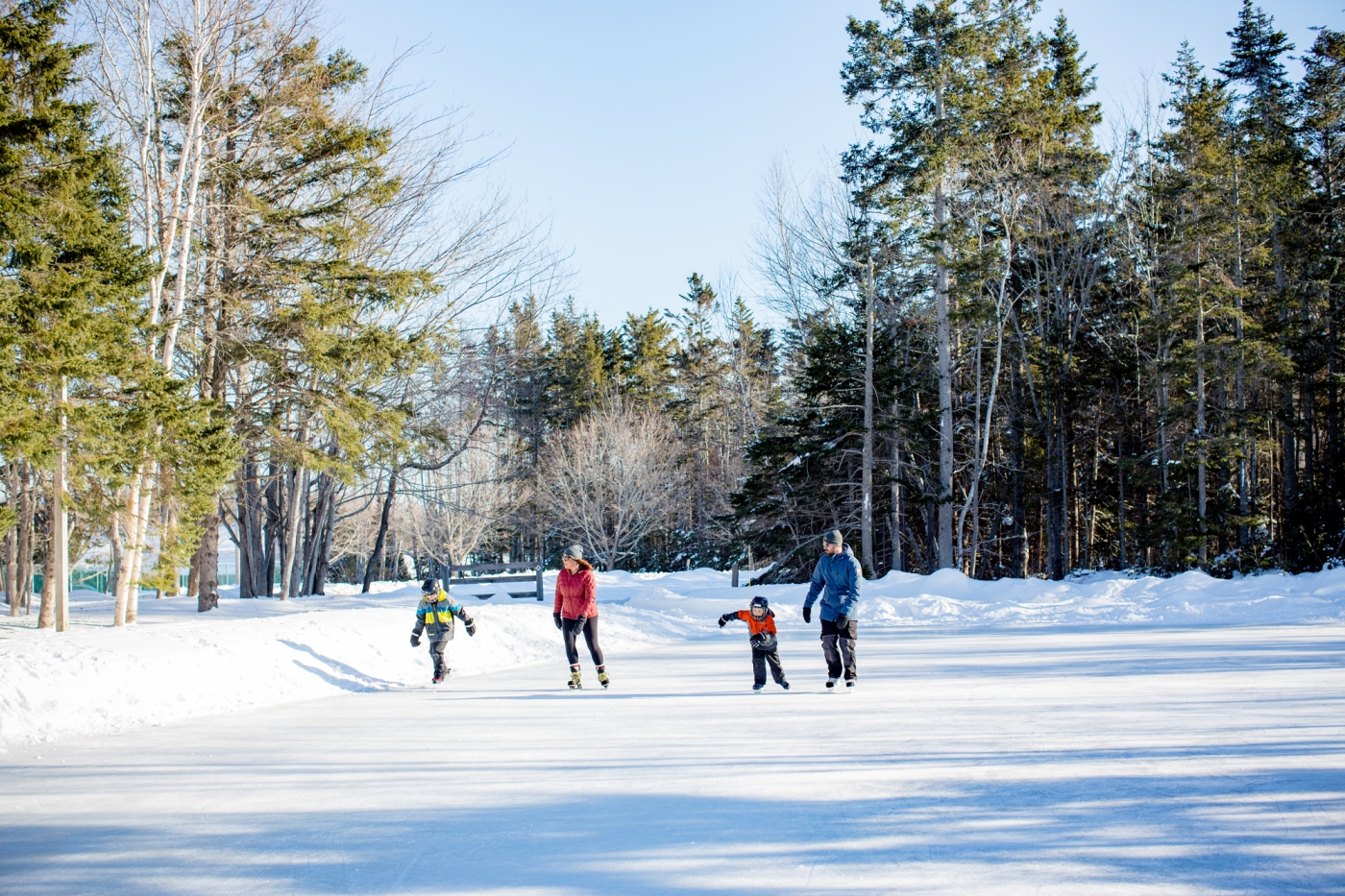 Family skating outdoors at Mill River Resort